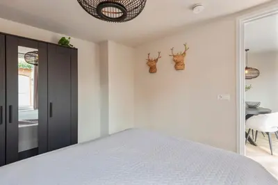 a bedroom with a bed and two deer heads on the wall at Short Stay Zandvoort at 68A in Zandvoort