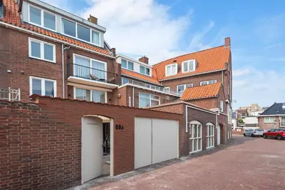a brick building with two white garage doors at Short Stay Zandvoort at 68A in Zandvoort