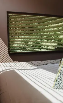 a bed in a room with a window with at Zoomers aan het Bos in Castricum