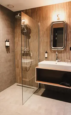 a bathroom with a tub and a sink at Zoomers aan het Bos in Castricum