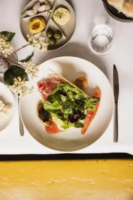 a plate of food with a salad on a table at Zoomers aan het Bos in Castricum