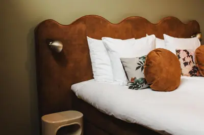 a bed with a teddy bear sitting on it at Zoomers aan het Bos in Castricum