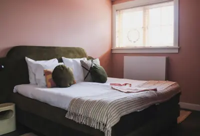 a bedroom with a large bed with a window at Zoomers aan het Bos in Castricum
