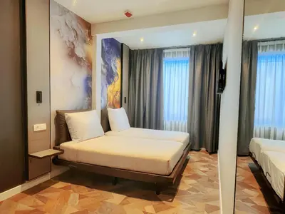 a hotel room with a bed and two windows at Nebula Hotel by Ine's in Assendelft