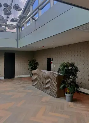 an empty room with two potted plants and a staircase at Nebula Hotel by Ine's in Assendelft