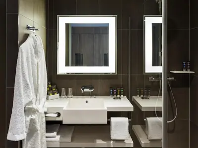 a bathroom with two sinks and a mirror at Novotel Amsterdam Schiphol Airport in Hoofddorp