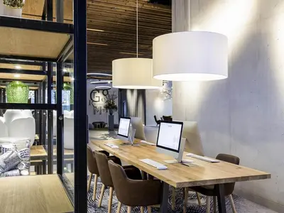 a conference room with a long wooden table with chairs at Novotel Amsterdam Schiphol Airport in Hoofddorp