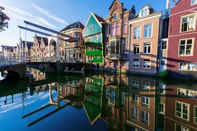 a reflection of buildings in the water of a canal at Authentic townhouse Alkmaar in Alkmaar