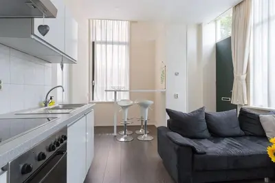 a living room with a couch in a kitchen at Authentic townhouse Alkmaar in Alkmaar