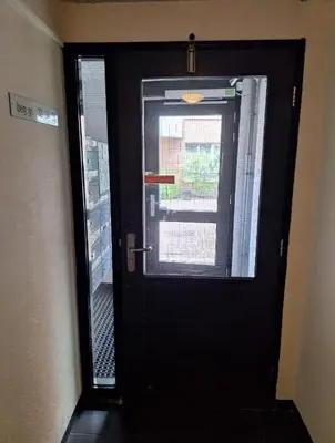 a black door with a window in a room at B Center charming room on the canal in Amsterdam