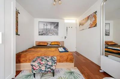 a bedroom with a bed and a mirror at B Center charming room on the canal in Amsterdam
