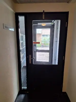 a black door with a window in a room at B Center charming room on the canal in Amsterdam