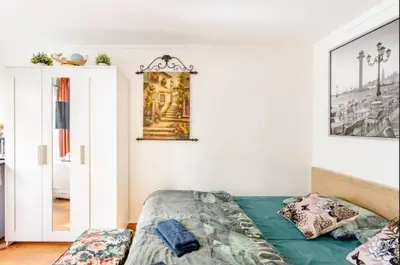 a bedroom with a bed and a picture on the wall at B Center charming room on the canal in Amsterdam