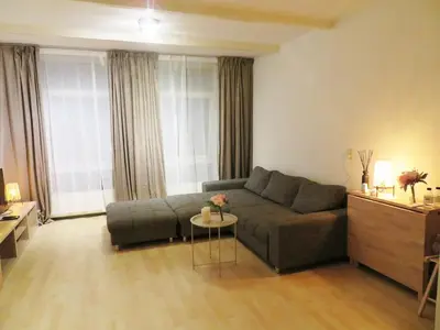 a living room with a couch and a table at Cozy Apartment in Alkmaar Centre in Alkmaar