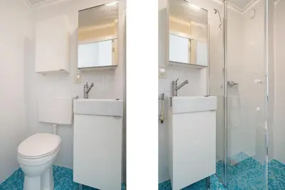 a bathroom with two sinks and a toilet at Cozy Apartment in Alkmaar Centre in Alkmaar
