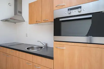 a kitchen with a sink and a stove at Cozy Apartment in Alkmaar Centre in Alkmaar