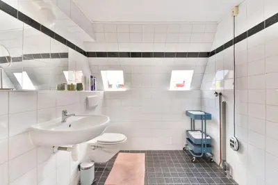 a white bathroom with a sink and a toilet at De Laat Vintage in Alkmaar