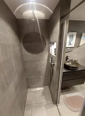 a bathroom with a shower with a sink and a mirror at SM Center located room on the canal in Amsterdam