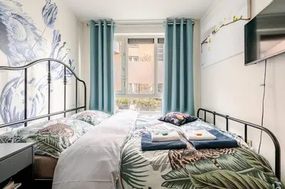 a bedroom with a bed with blue curtains at SM Center located room on the canal in Amsterdam