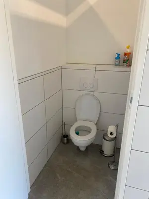 a small bathroom with a toilet in a stall at Luxe Glamping tent met sterrenhemel in Rijsenhout