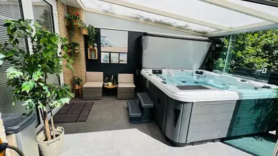 a jacuzzi tub sitting on a patio at Modern and luxury vacation house, private Jacuzzi in Zoetermeer