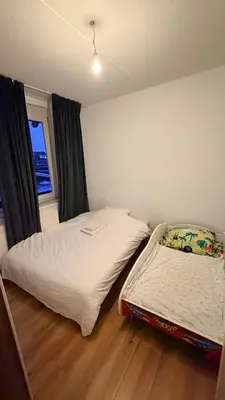 a small bedroom with a bed and a window at Modern and luxury vacation house, private Jacuzzi in Zoetermeer