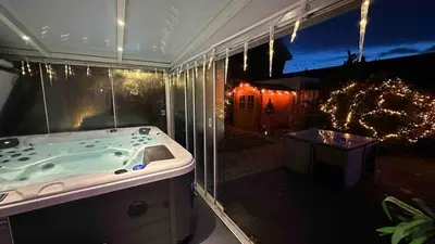 a bathroom with a tub and a view of a yard at Modern and luxury vacation house, private Jacuzzi in Zoetermeer