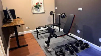 a room with a gym with two chairs and a desk at Modern and luxury vacation house, private Jacuzzi in Zoetermeer