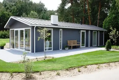 a small shed with a bench in a yard at EuroParcs Buitenhuizen in Velsen-Zuid
