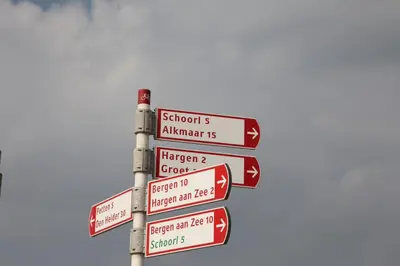 a street sign with many signs in different languages at EuroParcs Molengroet in Noord-Scharwoude
