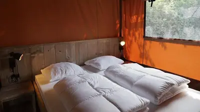 two beds sitting next to each other in a room at EuroParcs Molengroet in Noord-Scharwoude