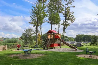 a park with a playground with a slide at EuroParcs Spaarnwoude in Halfweg