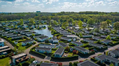 an aerial view of a village with houses and a river at EuroParcs Spaarnwoude in Halfweg