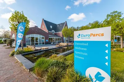 a sign in the grass in front of a building at EuroParcs Spaarnwoude in Halfweg