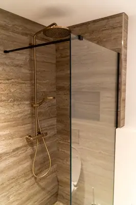 a shower with a glass door in a bathroom at Boerderie De Gouden Leeuw in Voorschoten