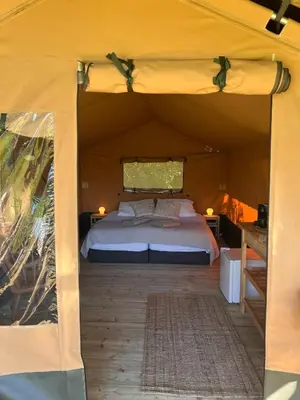 a bedroom with a bed in a tent at Een luxe safari tent in Rijsenhout
