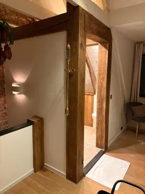 an open wooden door in a room with a table at Bellamy Suites in Amsterdam