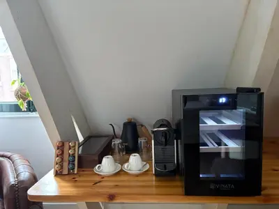 a microwave sitting on top of a wooden table at Bellamy Suites in Amsterdam