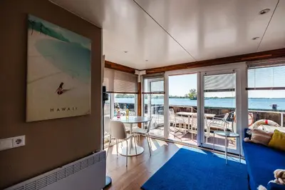 a living room with a view of the ocean at Floating Holiday Home - 15 mins to AMS in Vinkeveen