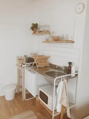 a kitchen with a sink and a microwave at Unique Tiny House close to Ams Airport with Hottub in Rijsenhout