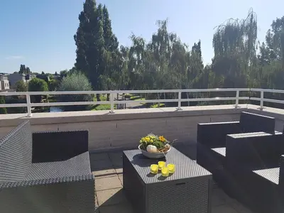 a balcony with chairs and a bowl of fruit on a table at Lil Amsterdam Topfloor a room ensuite with balcony in Uithoorn