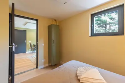 a bedroom with a bed and a sliding glass door at Blissea in Zandvoort