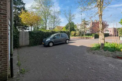 a small blue car parked in a parking lot at Blissea in Zandvoort