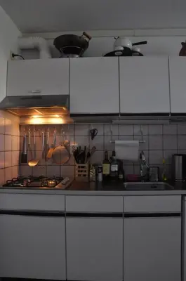 a kitchen with white cabinets and a counter top at Gemütliches Ferienhaus am Meer in Ons Belang