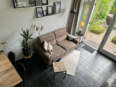 a living room with a couch and a table at Vorstelijk verblijf Alkmaar in Alkmaar