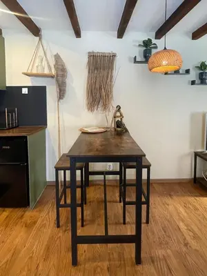 a kitchen with a wooden table in a room at Sandy soul escape in Zandvoort