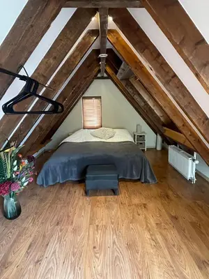a bedroom with a bed in a attic at Sandy soul escape in Zandvoort