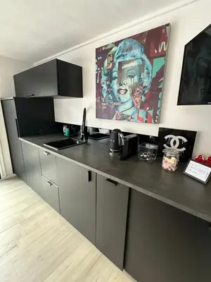 a kitchen with a black counter top in a room at Amsterdam-Houseboat-Amstel in Amsterdam