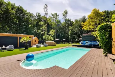 a swimming pool in the backyard of a house at Trio Lodge in Zeewolde