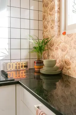 a sign that says coffee college on a counter in a kitchen at Nice bright studio near the forest and Amsterdam in Baarn
